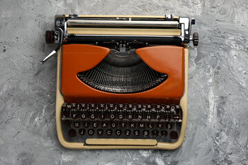 Vintage typewriter on grey background, top view