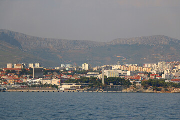 Fototapeta premium Contemporary buildings, gardens and beaches at the waterfront in Split, Croatia. View of Split from the boat.