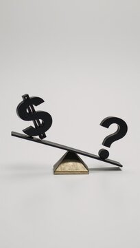 A teetering seesaw balances a  sign with a  encapsulating the eternal battle between financial stability and uncertainty