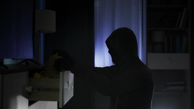 theft of someone elses property, a male offender in a balaclava is looking for valuables and money in other people things at night