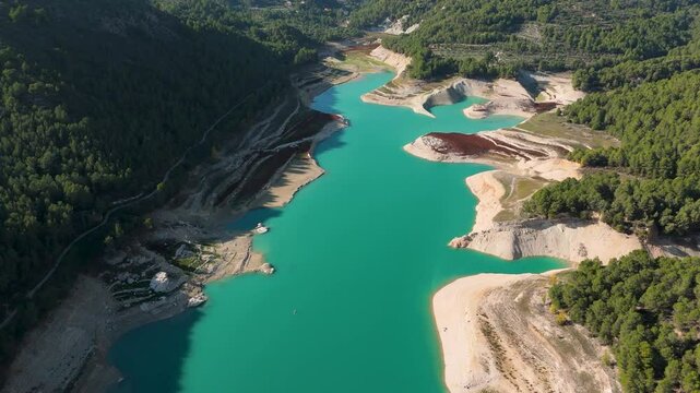 Embalse de Guadalest in Spain: Showcasing the turquoise waters and surrounding lush vegetation. A serene landscape captured by drone