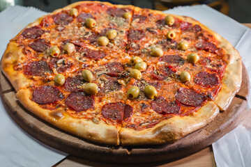 Delicious pizza topped with olives, mushrooms, and ham slices