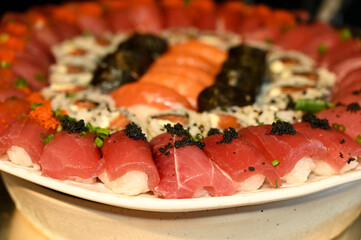 sushi on a plate, sushi with salmon and caviar, salmon and caviar, sushi with salmon,  table setting, haute cuisine, japanese food, raw salmon, buffet, restaurant, raw fish
