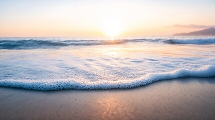Obraz premium Gentle ocean waves at sunrise on sandy beach. Ideal for wellness and meditation themes.