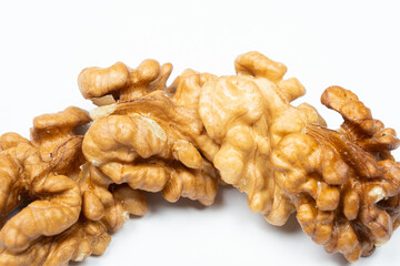 Shelled walnuts on a white background close-up