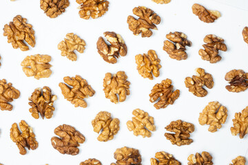 Walnut kernels, white background, top view.