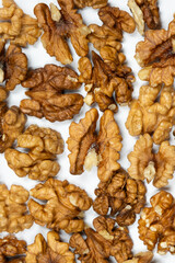 Walnut kernels, white background, top view.