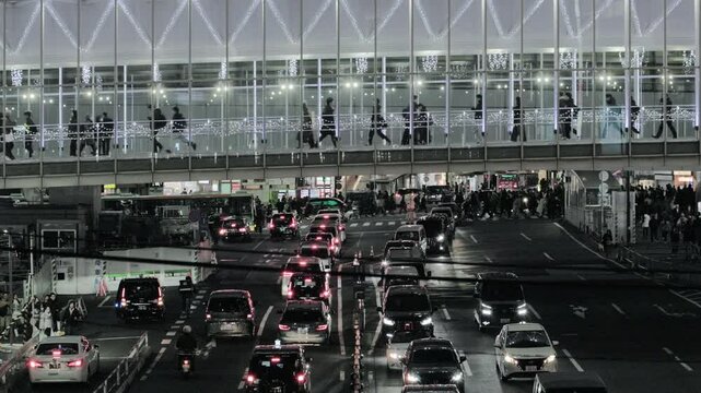 Night in Tokyo : The Illuminated Pedestrian Skyway, The Station Road Below, the Busy Intersection in the Back  |  Shibuya Station, Tokyo, Japan