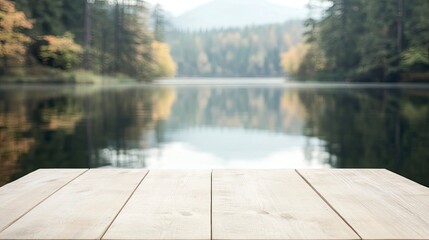 Serene lakeside view from a wooden dock surrounded by trees and misty mountains in the distance