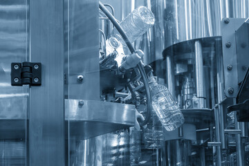 The overhead conveyor belt transport the drinking water bottle for filling process.