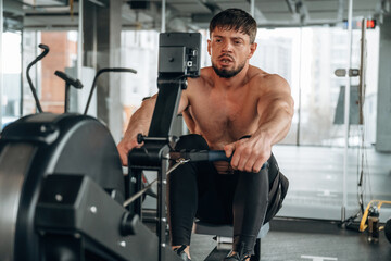 Preparing, doing cardio. Man is in the modern gym