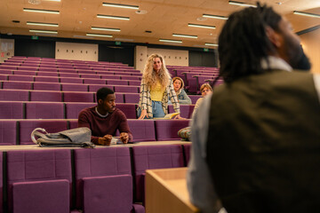 Students listening to teacher in university lecture hall
