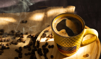 Top view of Colombian coffee cup filled with hot coffee with foam. on a wooden plate with scattered...