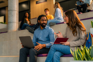 University students collaborating on project, sharing ideas in modern campus setting