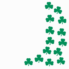 Fototapeta premium Green Lucky Shamrocks paper cut outs on a white background with copy space.