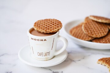 Mini Stroopwafels with a cup of hot tea,  selective focus