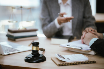 Lawyer Legal counsel presents to the client a signed contract with gavel and legal law. justice and lawyer Business partnership meeting concept.