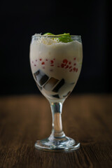 A delicious dessert drink featuring layers of cream and colorful toppings