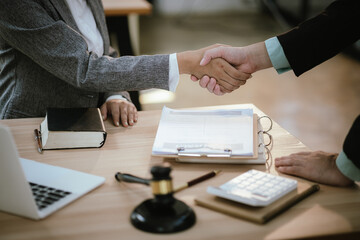 Lawyer Legal counsel presents to the client a signed contract with gavel and legal law. justice and lawyer Business partnership meeting concept.