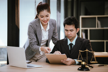 Lawyer Legal counsel presents to the client a signed contract with gavel and legal law. justice and lawyer Business partnership meeting concept.