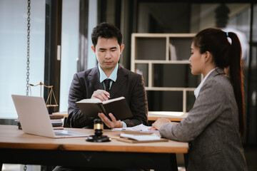 Lawyer Legal counsel presents to the client a signed contract with gavel and legal law. justice and lawyer Business partnership meeting concept.