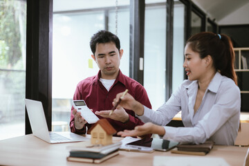 Real estate professionals meet with clients to discuss real estate investing, sales, and mortgage options. They review contracts to ensure a safe and successful transaction.