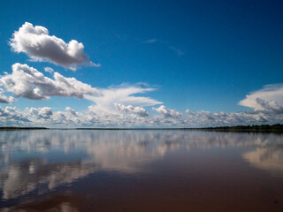 Amazon river landscape. Clouds are reflected on the huge expanse of water in the Amazon.