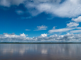 Amazon river landscape. Clouds are reflected on the huge expanse of water in the Amazon.
