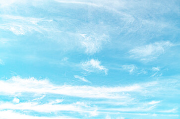 clear blue sky with a few clouds. The sky is very bright and the clouds are scattered throughout