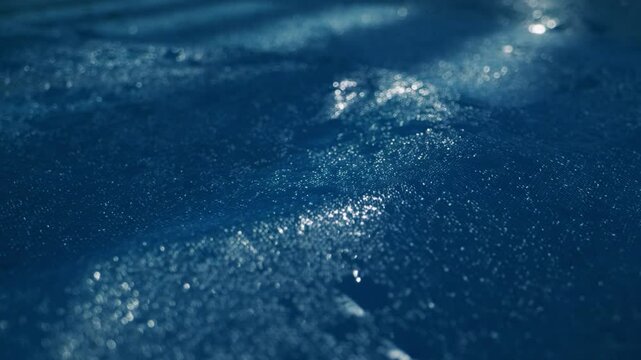 Tranquil Water Surface with Raindrops in Beautiful Blue Hues Captivating the Mind