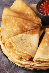 Freshly baked pancakes with red caviar
