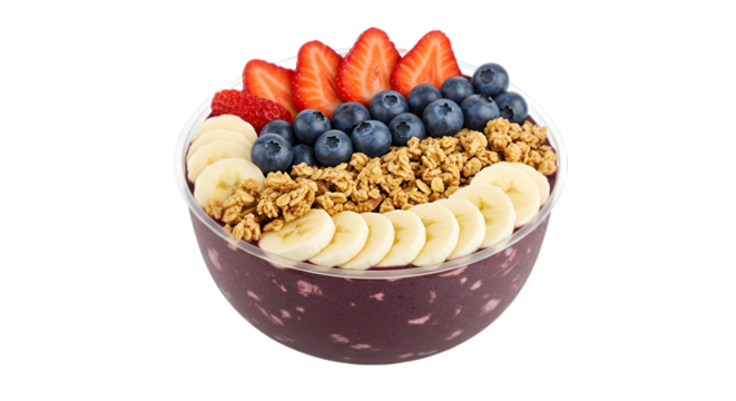 A vibrant acai bowl topped with fresh strawberries blueberries banana slices and crunchy granola in a clear bowl