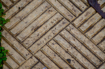 Very old beige tile in the street.