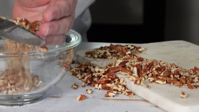 Baking a pecan pie in a rustic kitchen using a 100 year old recipe loaded with pecans and a home made crust. Delicious homemade pecan pie.