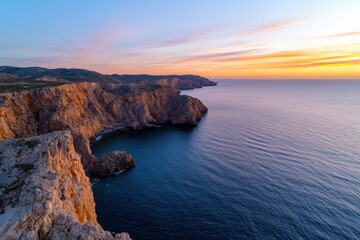 Breathtaking view of rugged cliffs meeting the vast ocean under a colorful sunset, evoking a sense...