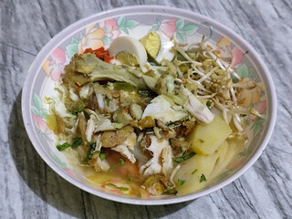 Soto Ayam in Indonesia. Soto ayam is a traditional Indonesian dish that uses ingredients such as shredded chicken, potatoes, eggs, rice vermicelli, bean sprouts with a delicious sauce.