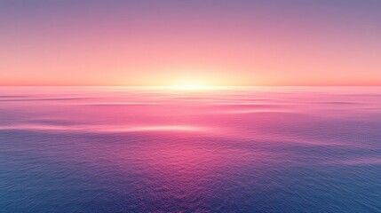 Fototapeta premium Pink and purple sunset over a calm ocean with a soft, hazy glow. The sun is low on the horizon, casting a warm light across the water. The sky is a
