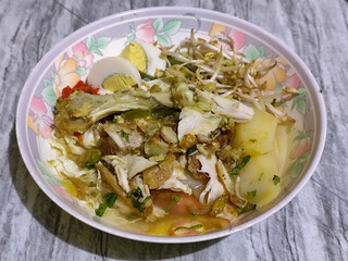 Soto Ayam in Indonesia. Soto ayam is a traditional Indonesian dish that uses ingredients such as shredded chicken, potatoes, eggs, rice vermicelli, bean sprouts with a delicious sauce.