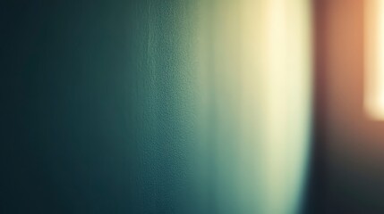 Close up of a teal wall surface with condensation forming a vertical line of water droplets. Soft, warm light from a window illuminates the right