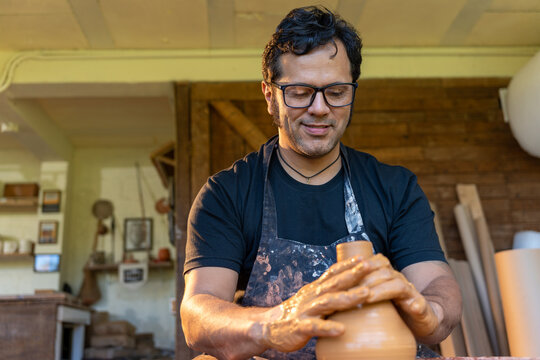 A skilled craftsman shapes clay into a stunning pottery piece, showcasing artistry