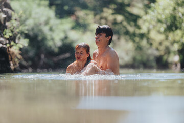 A joyful couple swimming in a serene river with lush greenery. Emphasizes romance, nature, and summer relaxation.