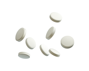 A collection of white tablets scattered on a surface, likely for medicinal use.