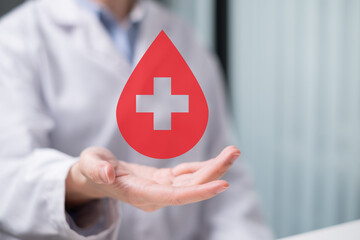 Professional health care worker doctor physician holding blood icon for blood donation concept