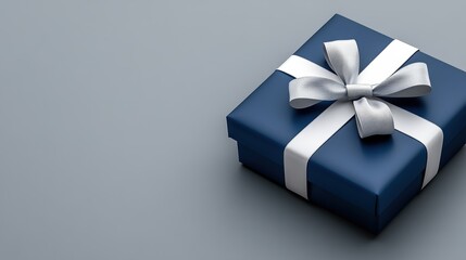 Elegant blue gift box with silver ribbon on minimalist gray background
