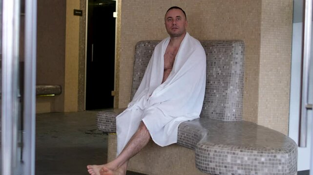 hamam man Oriental male bath attendant prepare soap solution for application to the client body in Turkish bath