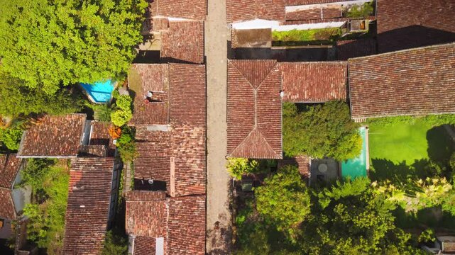 aerial view of old buildings and an old church in downtown of Paraty village. Sea and mountains at distance during noon