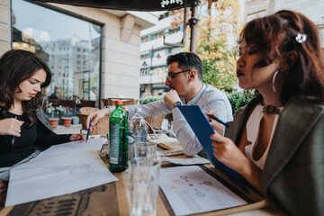 A group of diverse business people engage in a collaborative outdoor meeting, discussing documents and ideas in a relaxed setting. The scene captures teamwork and creativity in a professional