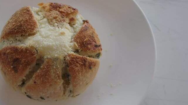 Korean cream cheese garlic bread on plat and raw garlic cloves