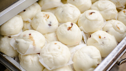 A stack of fresh steamed buns fresh from the oven