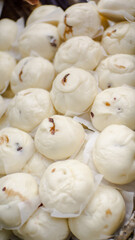 A stack of fresh steamed buns fresh from the oven
